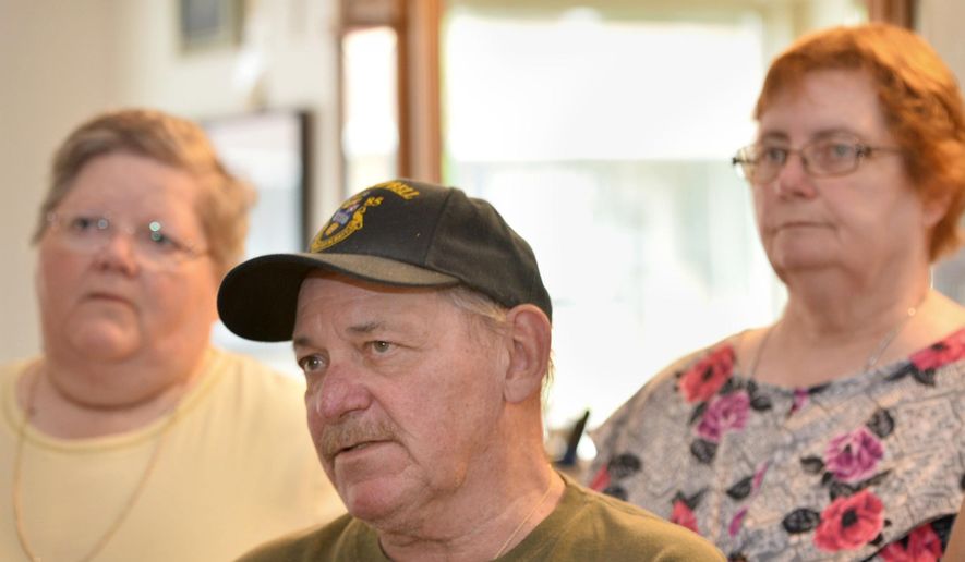 ADVANCE FOR WEEKEND EDITIONS - In this July 10, 2017, photo, Carole Rickrode, 69, from left, Robert Rickrode, 67, and Diane Garren, 70, visit their brother Ed Rickrode's barber shop in Wesleyville, Pa. They were remembering when their mother Lucille Rickrode, who was 43 at the time, was fatally shot by a stranger in her Greene Township home on July 24, 1967. (Christopher Millette/Erie Times-News via AP)