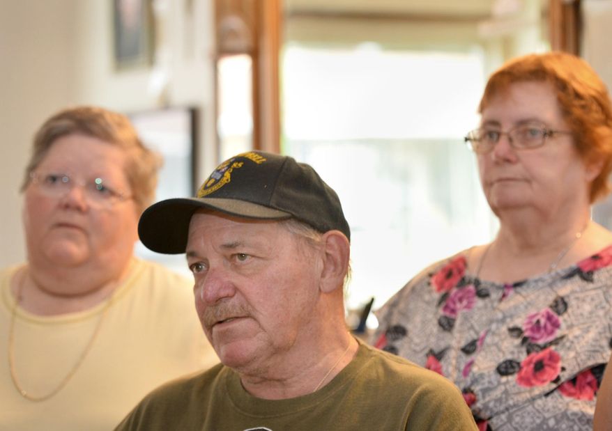 ADVANCE FOR WEEKEND EDITIONS - In this July 10, 2017, photo, Carole Rickrode, 69, from left, Robert Rickrode, 67, and Diane Garren, 70, visit their brother Ed Rickrode's barber shop in Wesleyville, Pa. They were remembering when their mother Lucille Rickrode, who was 43 at the time, was fatally shot by a stranger in her Greene Township home on July 24, 1967. (Christopher Millette/Erie Times-News via AP)