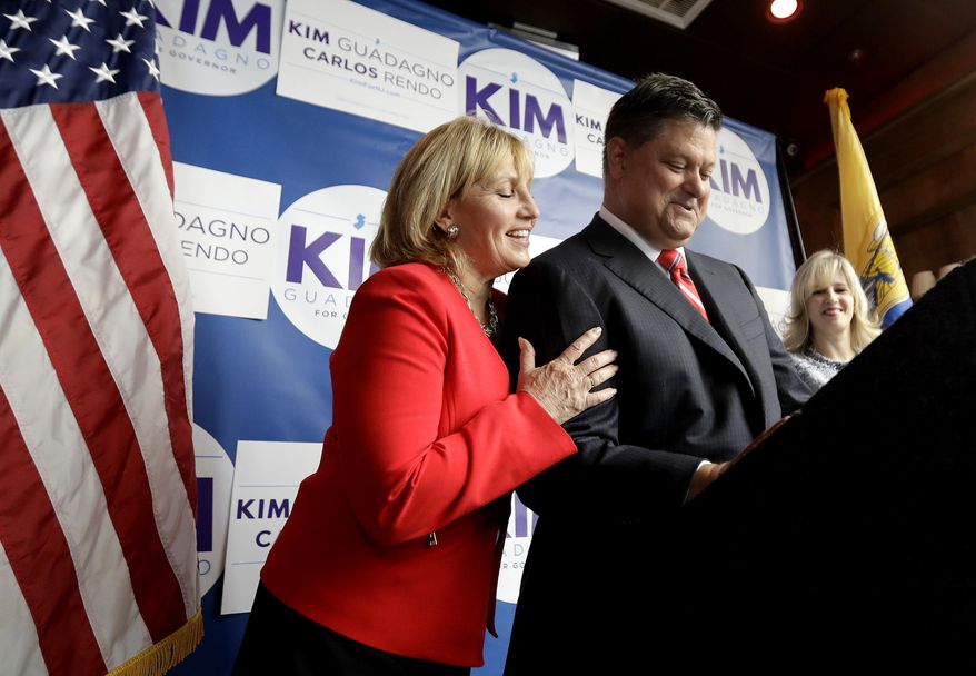 Carlos Rendo, center, mayor of Woodcliff Lake, N.J., speaks as New Jersey's Republican candidate for governor Lt. Gov. Kim Guadagno, left, embraces him during a news conference announcing Rendo as Guadagno's running mate, Thursday, July 27, 2017, in West New York, N.J. (AP Photo/Julio Cortez)