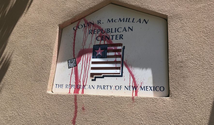 A spray painted "A" is shown on the offices of the Republican Party of New Mexico in Albuquerque after party officials say two protesters vandalized the building before fleeing on Thursday, July 17, 2017. The two protesters who said they from were the activist group Betsy Riot demonstrated outside the offices of the Republican Party of New Mexico and left before police arrived. (AP Photo/Russell Contreras)