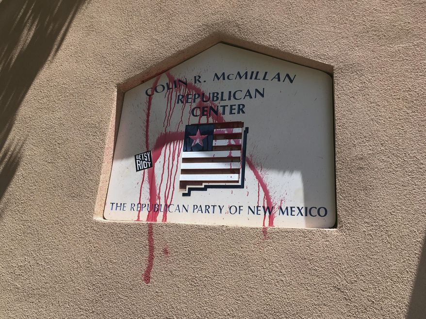 A spray painted "A" is shown on the offices of the Republican Party of New Mexico in Albuquerque after party officials say two protesters vandalized the building before fleeing on Thursday, July 17, 2017. The two protesters who said they from were the activist group Betsy Riot demonstrated outside the offices of the Republican Party of New Mexico and left before police arrived. (AP Photo/Russell Contreras)