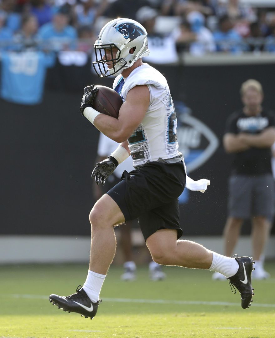 Carolina Panthers' Christian McCaffrey (22) runs with the ball during practice at training camp at Wofford College in Spartanburg, S.C., Wednesday, July 26, 2017. (AP Photo/Chuck Burton)