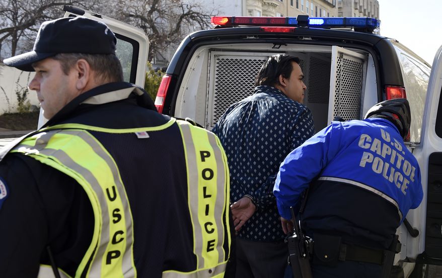 A protester is arrested on Capitol Hill in Washington, Wednesday, Feb. 11, 2015. According to the press release from Alliance for Citizenship, many people were "protesting inside the Capitol Hill offices of Republican 2016 hopefuls, leadership, and outspoken anti-immigrant leaders." (Associated Press) **FILE**
