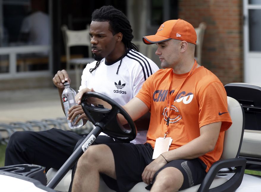 Chicago Bears wide receiver Kevin White, left, arrives for an NFL football training camp in Bourbonnais, Ill., Wednesday, July 26, 2017. (AP Photo/Nam Y. Huh)