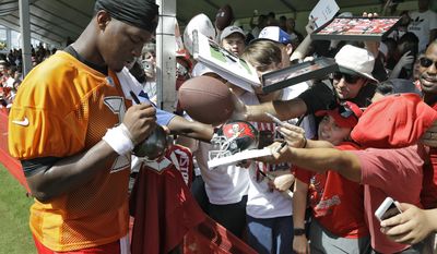 Tampa Bay Buccaneers quarterback Jameis Winston (3) signs autographs for fans after an NFL football training camp practice Friday, July 28, 2017, in Tampa, Fla. (AP Photo/Chris O&#39;Meara)