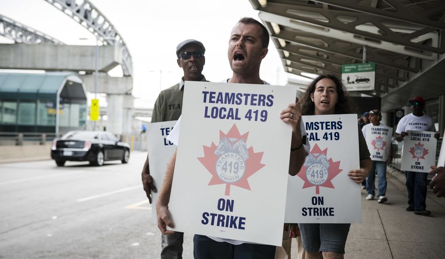 Striking workers picket at Pearson International Airport in Toronto on Friday, July, 28, 2017. Canada’s busiest air hub is advising travelers to check the status of their flights and says it will provide updates as they become available.The striking workers are employed by Swissport and include baggage and cargo handlers, cabin cleaners and other ground crew. (Christopher Katsarov/The Canadian Press via AP)