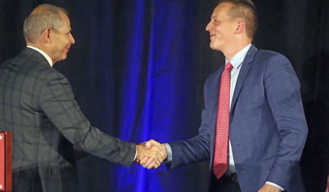 Republican candidates John Curtis, left, and Tanner Ainge shake hands following a debate at the Utah Valley Convention Center Friday, July 28, 2017, in Provo, Utah. Republican candidates Chris Herrod, Curtis, and Ainge, vying for the seat vacated by U.S. Rep. Jason Chaffetz, debated on topics ranging from health care to religious freedom. (AP Photo/Rick Bowmer)