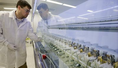 FILE - In this Thursday, Dec.18, 2014, file photograph, scientist Christopher Kistler checks on experiments in AMBR250 bio-reactors in a laboratory at the Merck company facilities in Kenilworth, N.J. Merck &amp;amp; Company, Inc. reports earnings, Friday, July 28, 2017. (AP Photo/Mel Evans, File)