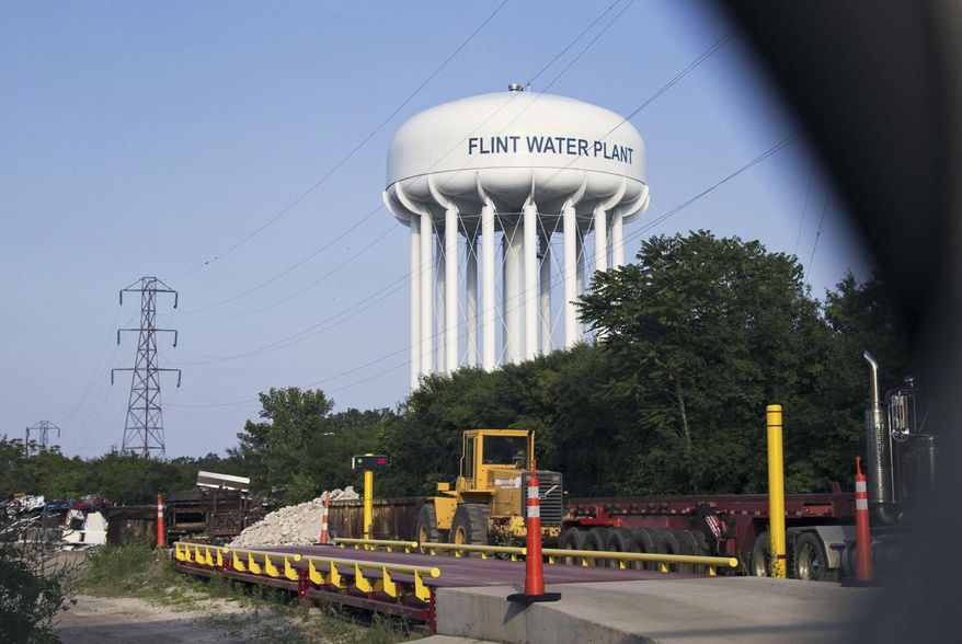 FILE - In this June 14, 2017, file photo, the Flint Water Plant tower is seen in Flint, Mich. A federal appeals court on Friday, July 28, 2017, says Flint residents who used lead-contaminated water can pursue constitutional claims against Michigan and city officials. (Shannon Millard/The Flint Journal-MLive.com via AP, File)