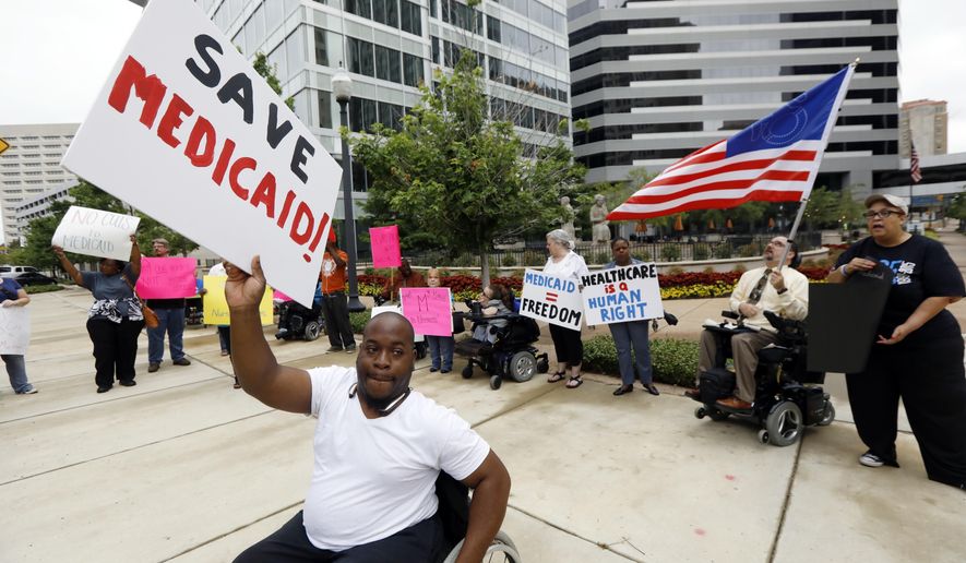 Mario Henderson leads chants of &amp;quot;save Medicaid,&amp;quot; as other social service activists, Medicaid recipients and their supporters stage a protest outside the building that houses the offices of U.S. Sen. Thad Cochran, R-Miss., Thursday, June 29, 2017, in Jackson, Miss. Soaring prices and fewer choices may greet customers when they return to the Affordable Care Act’s insurance marketplaces in the fall of 2017, in part because insurers are facing deep uncertainty about whether the Trump administration will continue to make key subsidy payments and enforce other parts of the existing law that help control prices. (AP Photo/Rogelio V. Solis)