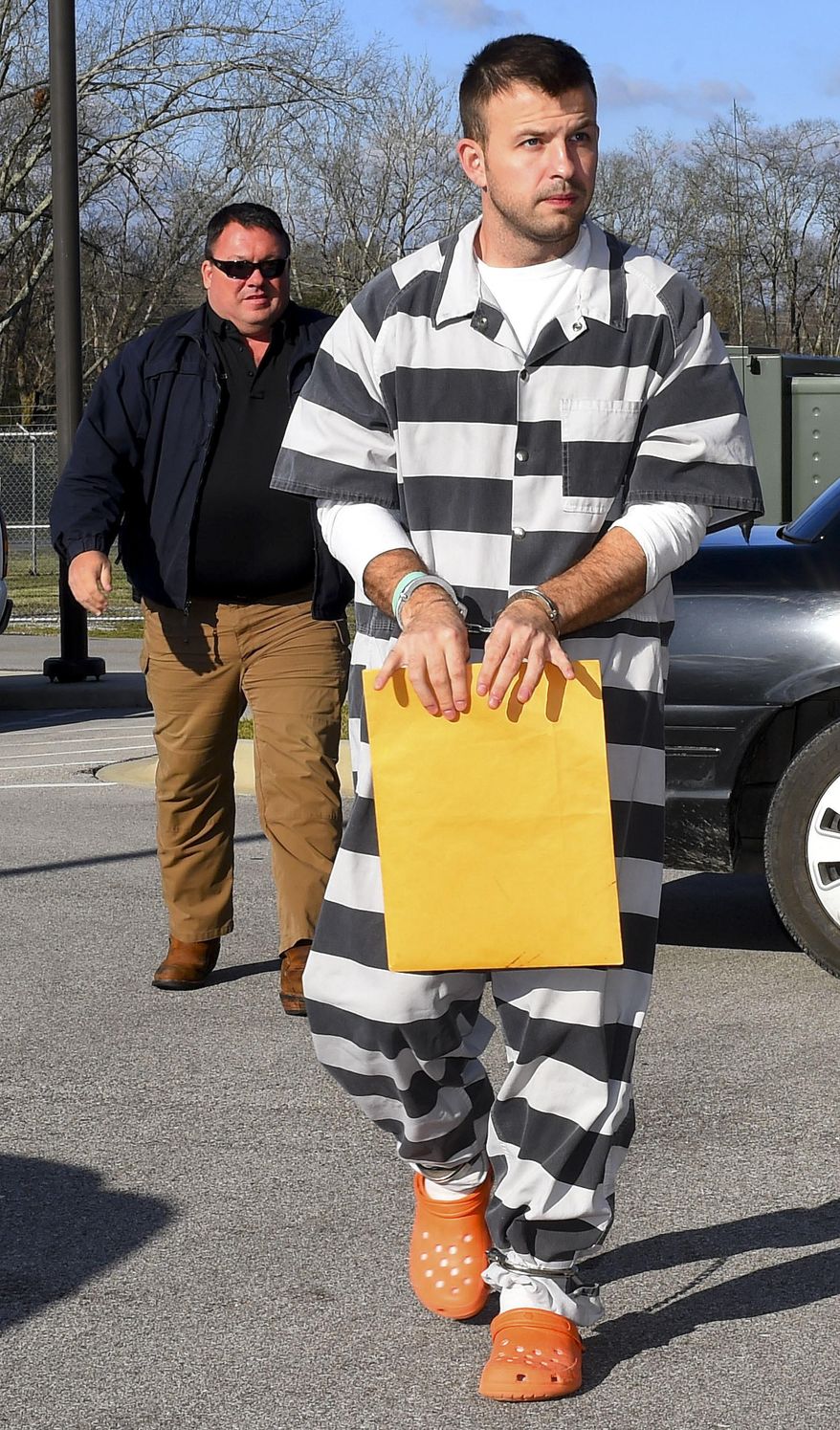 ADVANCE FOR USE MONDAY, JULY 31, 2017 AND THEREAFTER-In this March 15, 2017 photo, Evan Miller, foreground, is escorted to the Lawrence County Courthouse in Moulton, Ala. Miller was convicted at the age of 14 for the 2003 murder of Cole Cannon. At the resentencing hearing, Miller's lawyers cited his childhood of physical abuse and neglect and argued that at 14, his brain wasn't fully developed. The prosecution said his actions were those of an adult who acted mercilessly. (John Godbey/The Decatur Daily via AP)