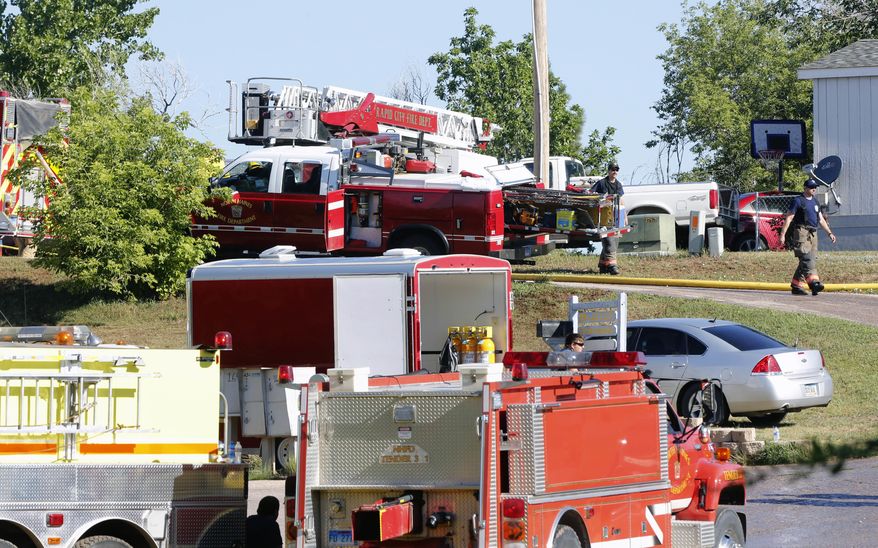 Emergency responders investigate the scene of a mobile home fire, Friday, July 28, 2017 in Rapid City, S.D. A fire official says multiple people are unaccounted after a fire destroyed a mobile home in western South Dakota. (Chris Huber/Rapid City Journal via AP)