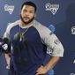 FILE - In this April 10, 2017, file photo, Los Angeles Rams defensive lineman Aaron Donald speaks with reporters after the first official day of the team&#39;s offseason football training program in Thousand Oaks, Calif. Donald has not reported to the Rams’ training camp, and general manager Les Snead says the club will continue negotiations on a contract extension. Donald didn’t join his veteran teammates in reporting to UC Irvine on Friday, July 28. The fourth-year pro also skipped several weeks of offseason workouts while his agent worked on a new deal that will make him one of the highest-paid players in the NFL. (AP Photo/Greg Beacham, file)