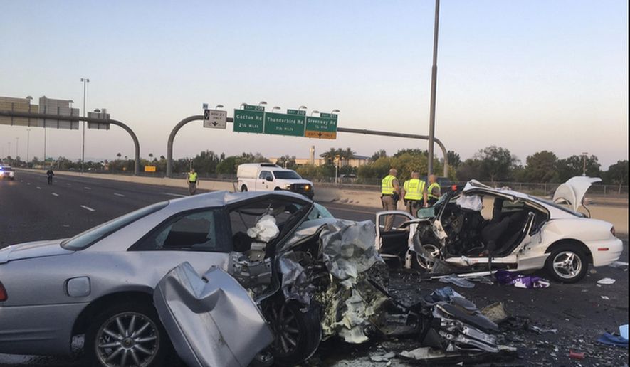 FILE - This Friday, April 14, 2017, file photo provided by the Arizona Department of Public Safety shows the mangled remains of cars involved in a fatal accident on the Northbound Interstate 17 in Phoenix, Ariz. Arizona transportation officials are moving forward with a first-in-the-nation pilot program that will use thermal camera technology to curb the wrong-way driving problem plaguing the state. The wrong-way detection system will illuminate a sign that notifies the wrong-way driver, and immediately alert the state Department of Public Safety. Arizona Department of Transportation officials will update message boards along the interstate that cautions other drivers of the wrong-way vehicle. (Arizona Department of Public Safety via AP)