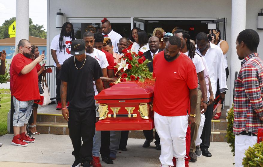 Pallbearers carry out a bright red casket at the funeral for Jamel Dunn, 31, at the Zion Orthodox Primitive Baptist Church Saturday, July 29, 2017, in Cocoa, Fla. Some attendees wore traditional dark clothing, while many others wore red at the request of the family. Florida prosecutors will decide whether to file charges against five teenagers who laughed and recorded video as the disabled man drowned on July 9. (Malcolm Denemark/Florida Today via AP)