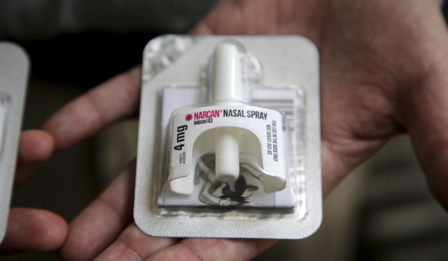 In this June 14, 2017, photo, Cook County Sheriff Tom Dart shows Naloxone, an overdose-reveal nasal spray drug at the sheriff's office in Cook County Jail, the largest single site jail in the United States, has joined the growing number of jails to hand to inmates on their way out the door kits containing naloxone. (AP Photo/G-Jun Yam)