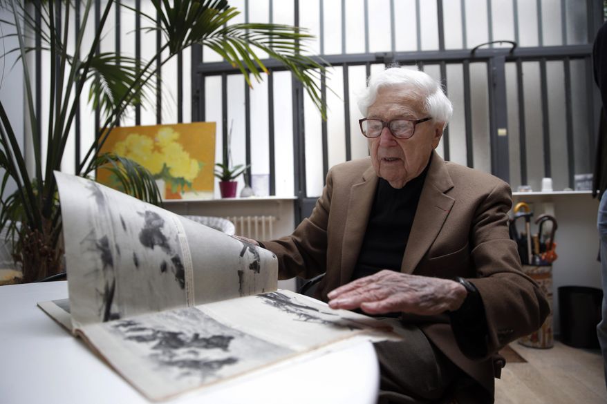 FILE- In this file photo dated Friday, May 2, 2014, John Morris, legendary Life Magazine and New York Times photo editor, speaks during an interview with the Associated Press in Paris, France. The renowned picture editor who's pictorial judgement impacted on public understanding of seminal stories for decades including World War II and the Vietnam War, John G. Morris has died aged 100, Friday July 28, 2017, at a hospital near his home in Paris. (AP Photo/Christophe Ena, FILE)