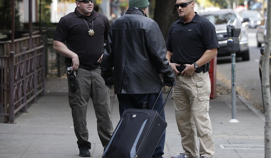 FILE -- In this Dec. 1, 2015 file photo, parole agents Andrew Correa, left, and Clint Cooley, right, talk with a sex-offender parolee they located by tracking the global positioning device he wears, in Sacramento, There are as many homeless sex offenders in California now as 2½ years ago when a state Supreme Court ruling that overturned restrictions on where they can live was seen as a way to increase housing options and allow law enforcement to better track them. (AP Photo/Rich Pedroncelli, file)