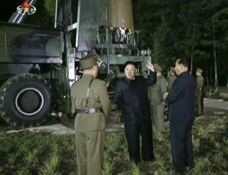 In this image made from video by North Korea's KRT on Friday, July 28, 2017, North Korean leader Kim Jung Un, center, gestures at the site of a missile test at an undisclosed location in North Korea. Kim said Saturday, July 29, 2017, the second flight test of an intercontinental ballistic missile demonstrated his country can hit the U.S. mainland, hours after the launch left analysts concluding that a wide swath of the United States, including Los Angeles and Chicago, is now in range of North Korean weapons. (KRT via AP Video)