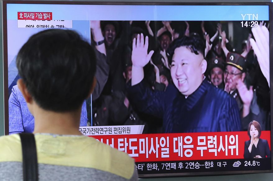 A man watches a TV news program showing an image of North Korean leader Kim Jong Un during the North's latest test launch of an intercontinental ballistic missile, at Seoul Railway Station in Seoul, South Korea, Saturday, July 29, 2017. The clear message after Friday’s late-night test, the second in a month of a missile that may be able to reach most of the U.S. mainland: Get used to this _ it’s the new normal. The signs read "Military Demonstration." (AP Photo/Ahn Young-joon)