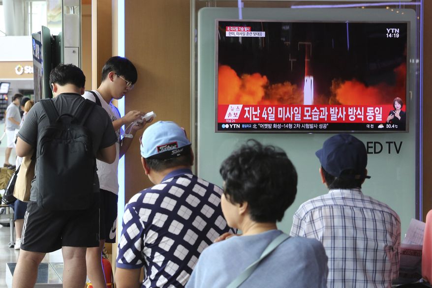 People watch a TV news program showing an image of North Korea's latest test launch of an intercontinental ballistic missile (ICBM), at the Seoul Railway Station in Seoul, South Korea, Saturday, July 29, 2017. North Korea on Friday test-fired its second intercontinental ballistic missile, which flew longer and higher than the first according to its wary neighbors, leading analysts to conclude that a wide swath of the U.S., including Los Angeles and Chicago, is now within range of Pyongyang's weapons. The signs read "North Korea launched in the same way as last July 4." (AP Photo/Ahn Young-joon)