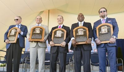Newly-inducted National Baseball Hall of Famers from left, Bud Selig, Ivan Rodriguez, John Schuerholz, Tim Raines Sr., and Jeff Bagwell hold their plaques after an induction ceremony at the Clark Sports Center on Sunday, July 30, 2017, in Cooperstown, N.Y. (AP Photo/Hans Pennink)