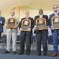 Newly-inducted National Baseball Hall of Famers from left, Bud Selig, Ivan Rodriguez, John Schuerholz, Tim Raines Sr., and Jeff Bagwell hold their plaques after an induction ceremony at the Clark Sports Center on Sunday, July 30, 2017, in Cooperstown, N.Y. (AP Photo/Hans Pennink)