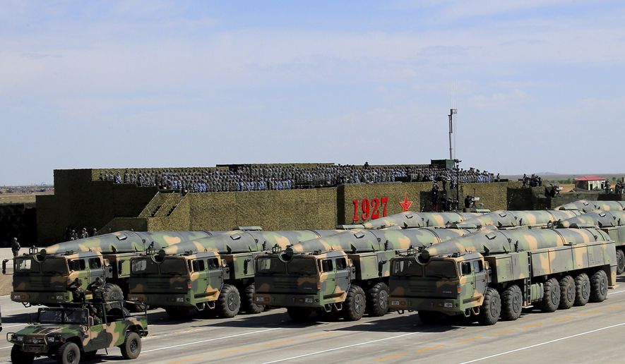 In this photo released by China&#39;s Xinhua News Agency, military vehicles carrying missiles for both nuclear and conventional strikes are driven past the VIP stage during a military parade to commemorate the 90th anniversary of the founding of the People&#39;s Liberation Army at Zhurihe training base in north China&#39;s Inner Mongolia Autonomous Region, Sunday, July 30, 2017. China&#39;s military has the &amp;quot;confidence and capability&amp;quot; to bolster the country&#39;s rise into a world power, President Xi Jinping said Sunday as he oversaw a large-scale military parade meant to show off the forces at his command to foreign and domestic audiences. (Zha Chunming/Xinhua via AP)