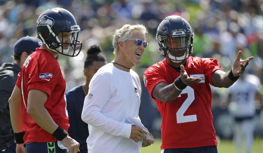 Seattle Seahawks head coach Pete Carroll, center, talks with backup quarterbacks Austin Davis, left, and Trevone Boykin, right, on the first day an NFL football training camp, Sunday, July 30, 2017, in Renton, Wash. (AP Photo/Ted S. Warren) ** FILE **