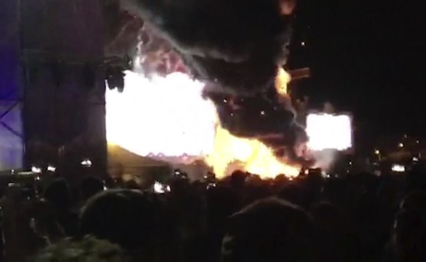In this image made from video provided by David Belmonte, flames engulf the outdoor stage during the "Tomorrowland" electronic music festival in Barcelona, Spain, Saturday night, July 29, 2017. A spectacular fire at the music festival forced the evacuation of over 20,000 concertgoers, the regional government says. (David Belmonte via AP)