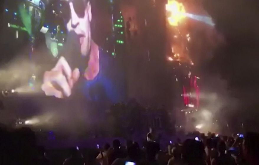 In this image made from video provided by David Belmonte, flames engulf the outdoor stage during the "Tomorrowland" electronic music festival in Barcelona, Spain, Saturday night, July 29, 2017. A spectacular fire at the music festival forced the evacuation of over 20,000 concertgoers, the regional government says. (David Belmonte via AP)