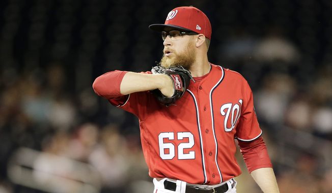 Washington Nationals relief pitcher Sean Doolittle pitches during the second game of a split double header baseball game between the Colorado Rockies and Washington Nationals, Sunday, July 30, 2017, in Washington. (AP Photo/Mark Tenally)