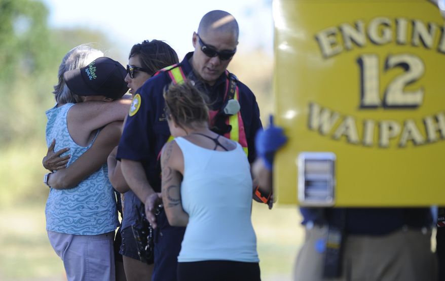 In this Saturday, July 29, 2017, photo, friends or relatives of the victims of the small plane crash arrive at an Honolulu Fire Department helicopter staging area in Kunia, Hawaii. Federal investigators haven't yet determined what caused the plane to crash in an inaccessible mountainous area on the island of Oahu. Hutton and his three passengers died in the crash. (Bruce Asato/The Star-Advertiser via AP)