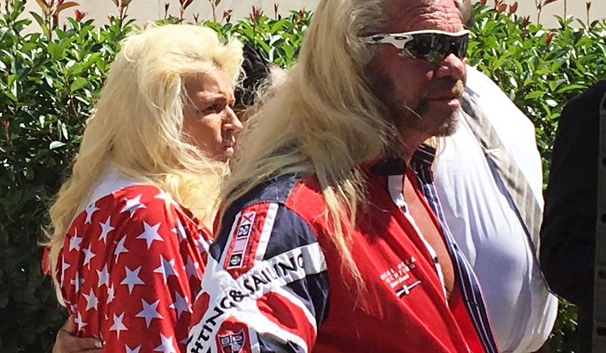 Duane "Dog" Chapman, center, joins the family of Christian Rodgers and their lawyers Monday, July 31, 2017, as they announce a wrongful death lawsuit that claims New Jersey's new bail reform measures are to blame for Rodgers' shooting death in April 2017, in Trenton, N.J. Chapman, the former star of the "Dog the Bounty Hunter" television show, has been an outspoken critic of the reforms, which proponents say are meant to keep defendants from being stuck in jail mainly because they can't afford bail. Defendants named in the suit include Gov. Chris Christie, who has championed the reforms, and state Attorney General Christopher Porrino. (AP Photo/Bruce Shipkowski)