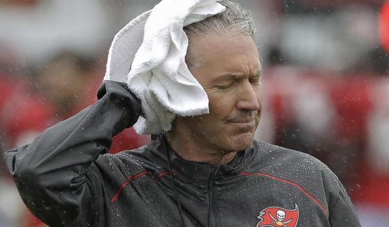 Tampa Bay Buccaneers head coach Dirk Koetter towels off as rains associated with Tropical Storm Emily falls during an NFL football training camp practice Monday, July 31, 2017, in Tampa, Fla. (AP Photo/Chris O&#39;Meara)