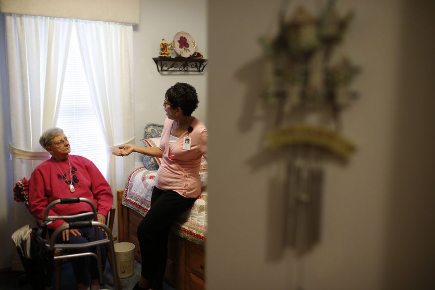 In this July 19, 2017, photo, nurse Sandy Miller, right, chats with patient Martha Hays, left, at the Hays home in Columbus, Ohio. U.S. Census estimates show the number of elderly people in the country is expected to more than double by 2050 to nearly 89 million, creating a growing need for more care workers. Geriatric care management has become a growing field. (Joshua A. Bickel/The Columbus Dispatch via AP)