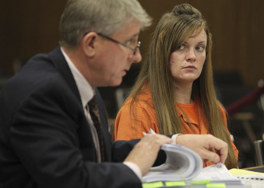 FILE - In this Tuesday Dec. 7, 2010 file photo, convicted murderer Sarah Johnson listens to her attorney, Christopher Simms, during her court hearing in Twin Falls, Idaho, to have her 2005 conviction for murdering her parents overturned. Simms says Johnson was unfairly convicted of killing her parents in 2003, at the age of 16, because police investigators failed to consider other suspects and a previous defense attorney who was unprepared. (Ashley Smith/The Times-News via AP)