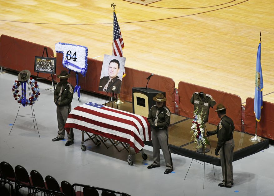 Oklahoma Highway Patrol Troopers stand at the casket of Lt. D. Heath Meyer before his funeral in Norman, Okla., Monday, July 31, 2017. Meyer, who was struck by another trooper's patrol car during a chase July 14, 2017, died July 24, 2017. (AP Photo/Sue Ogrocki)