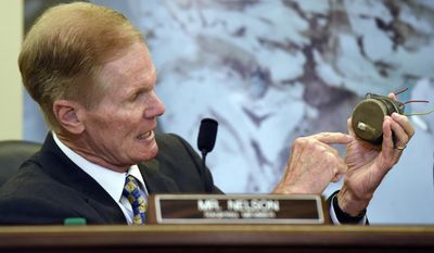 FILE - In this Tuesday, June 23, 2015, file photo, Sen. Bill Nelson, D-Fla., holds a Takata airbag inflator during a Senate Commerce, Science, and Transportation Committee hearing on Capitol Hill in Washington. A government effort to speed up recalls of more than 21 million of the most dangerous Takata air bag inflators is falling short, according to an analysis of completion rates by The Associated Press. (AP Photo/Susan Walsh, File)