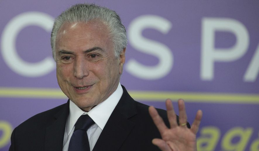 Brazil's President Michel Temer speaks during a ceremony at the Planalto Presidential Palace, in Brasilia, Brazil, Tuesday, Aug. 1, 2017. President Temer faces a congressional vote on his future Wednesday, a showdown coming in a month dreaded by leaders of Latin America's largest nation. August has seen Brazilian presidents impeached, resign and even kill themselves. (AP Photo/Eraldo Peres)
