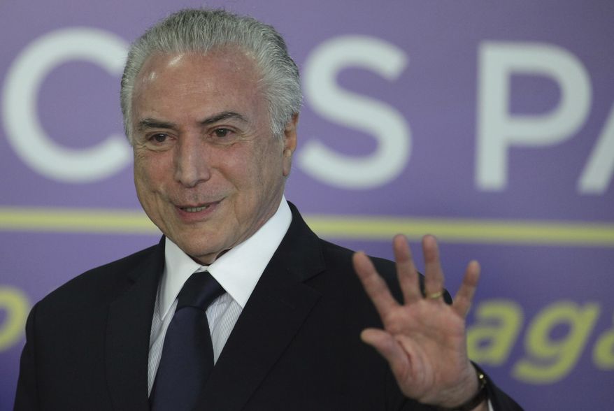Brazil's President Michel Temer speaks during a ceremony at the Planalto Presidential Palace, in Brasilia, Brazil, Tuesday, Aug. 1, 2017. President Temer faces a congressional vote on his future Wednesday, a showdown coming in a month dreaded by leaders of Latin America's largest nation. August has seen Brazilian presidents impeached, resign and even kill themselves. (AP Photo/Eraldo Peres)