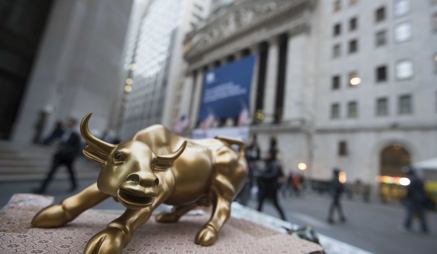FILE - In this Tuesday, Oct. 25, 2016, file photo, a miniature reproduction of Arturo Di Modica&#39;s &quot;Charging Bull&quot; sculpture sits on display at a street vendor&#39;s table outside the New York Stock Exchange, in lower Manhattan. U.S. Stocks are rising Tuesday, Aug. 1, 2017, as payment processors and banks trade higher. (AP Photo/Mary Altaffer, File)