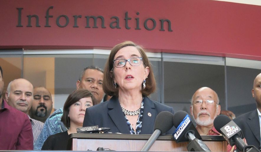 In this May 27, 2017, file photo, Oregon Gov. Kate Brown speaks at a news conference in Portland, Ore. Gov. Brown is authorizing the Oregon National Guard to deploy soldiers to help deal with an influx of tourists during August&#x27;s total solar eclipse. (AP Photo/Gillian Flaccus, File)