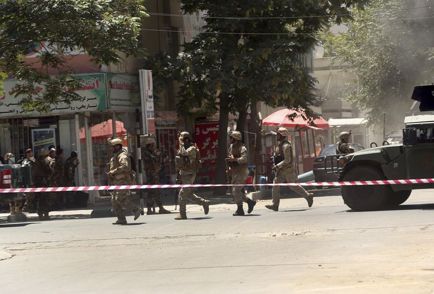 Security forces respond at the site of a suicide attack followed by a clash between Afghanistan's forces and IS fighters during an attack on Iraq embassy in Kabul, Afghanistan, Monday, July 31, 2017. A media outlet linked to the Islamic State group says two IS militants were behind the attack on the Iraqi Embassy in the Afghan capital. (AP Photos/Massoud Hossaini)