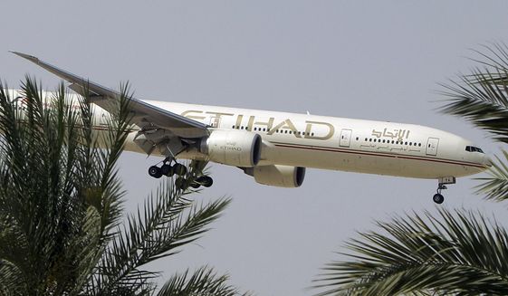 n this Sunday, May 4, 2014 file photo, an Etihad Airways plane prepares to land in Abu Dhabi Airport, United Arab Emirates. (AP Photo/Kamran Jebreili, File)