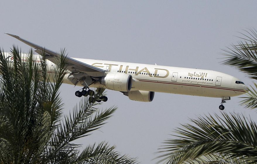 n this Sunday, May 4, 2014 file photo, an Etihad Airways plane prepares to land in Abu Dhabi Airport, United Arab Emirates. (AP Photo/Kamran Jebreili, File)