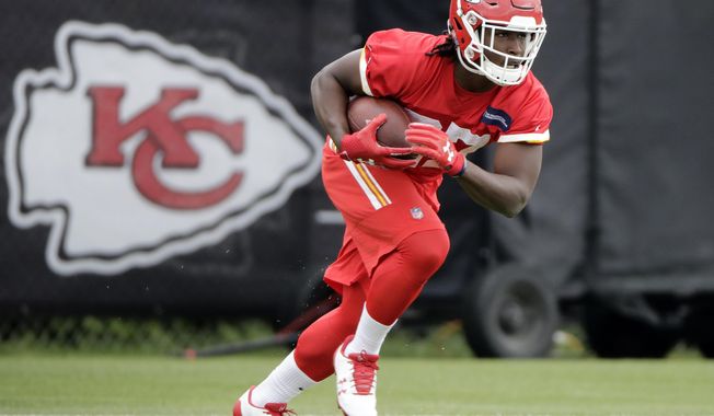 FILE - In this May 24, 2017, file photo, Kansas City Chiefs running back Kareem Hunt (27) participates in a drill during the team&#x27;s organized team activity at its NFL football training facility, in Kansas City, Mo. Ask anyone working with the Chiefs&#x27; offense who has been turning heads these days and chances are Kareem Hunt&#x27;s name will float to the surface. (AP Photo/Charlie Riedel, File)