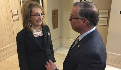 FILE--In this Feb. 22, 2017, file photo, former U.S. Congresswoman and shooting survivor Gabrielle Giffords, left, talks with Democratic New Mexico Sen. Daniel Ivey-Soto in Santa Fe, N.M. A national gun-safety group on Tuesday, Aug. 1, 2017, stepped up pressure in New Mexico against proposed U.S. firearms legislation that would make states recognize concealed handgun permits from other states.(AP Photo/Morgan Lee, file)