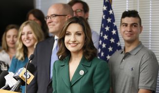 Joy Hofmeister, center, Oklahoma Superintendent of Schools, surrounded by her family, smiles during a news conference to announce that felony charges of illegally raising campaign money have been dismissed against her and four others, in Oklahoma City, Tuesday, Aug. 1, 2017. From left are daughter Liz Hofmeister, husband Judge Jerry Hofmeister, Joy Hofmeister and son Jimmy Hofmeister. (AP Photo/Sue Ogrocki)