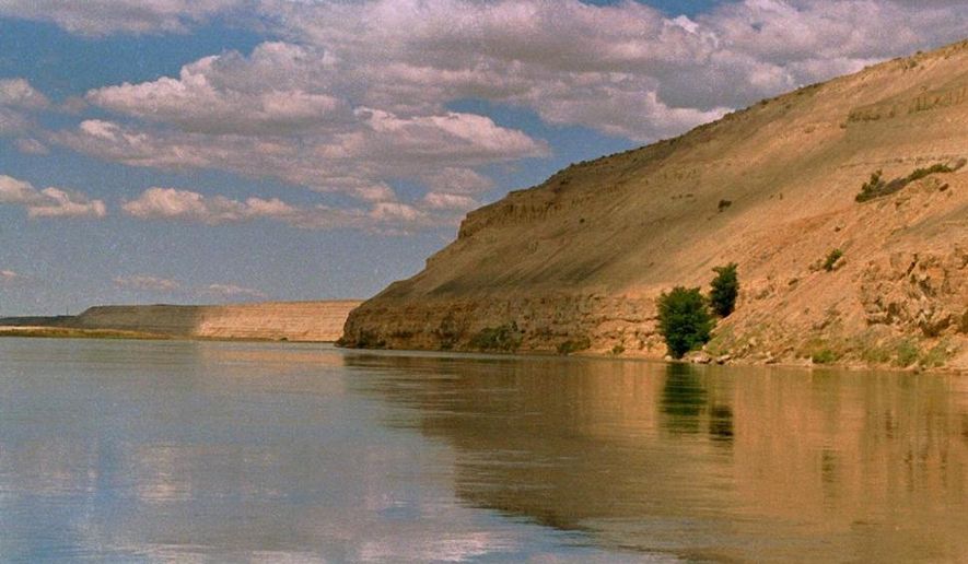 In this June 19, 2000, photo, bluffs along the Columbia River are among the scenic attractions of the Hanford Reach National Monument, Wash. Interior Secretary Ryan Zinke said Thursday, July 13, 2017 that Hanford Reach is no longer under review for possible modification of their protected status. (AP Photo/David Foster, File)